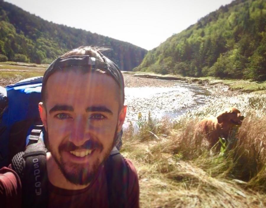 Alex Mayberry hiking with his dog Paul