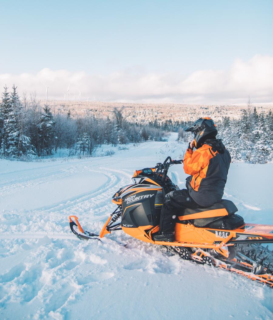 Snowmobiling in the Caledonia Highlands, near Kent Hills Wind Farm
