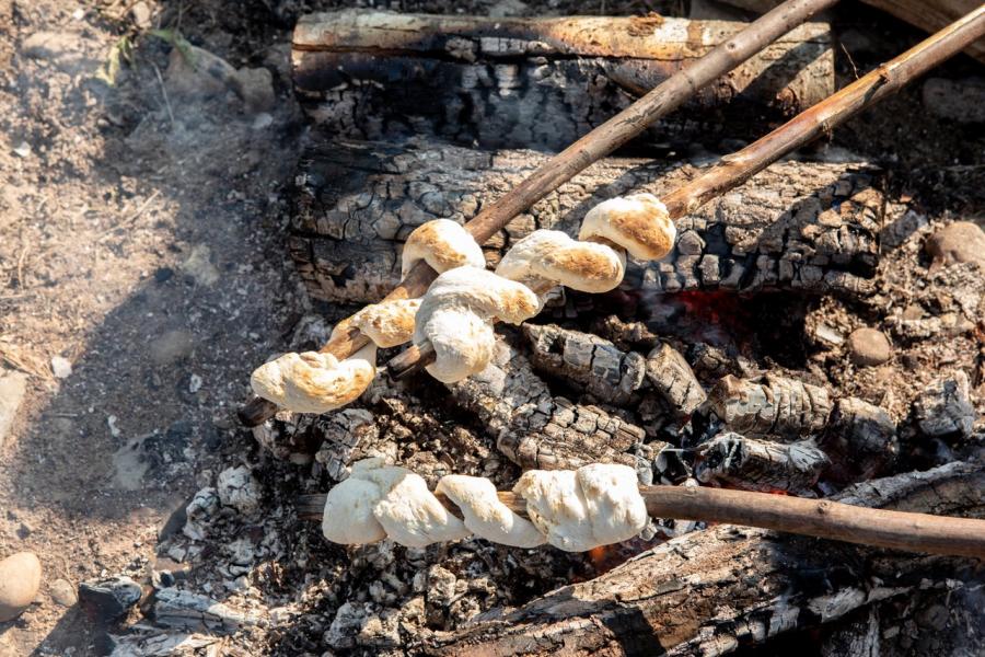 Bannock cooked on an open fire, Metepenagiag