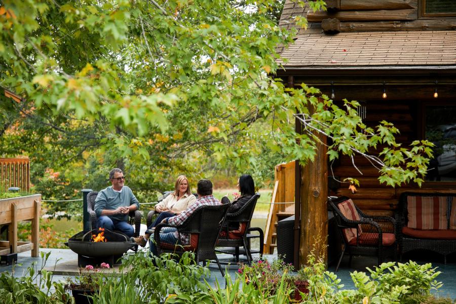 people sitting around a fire at ledges inn