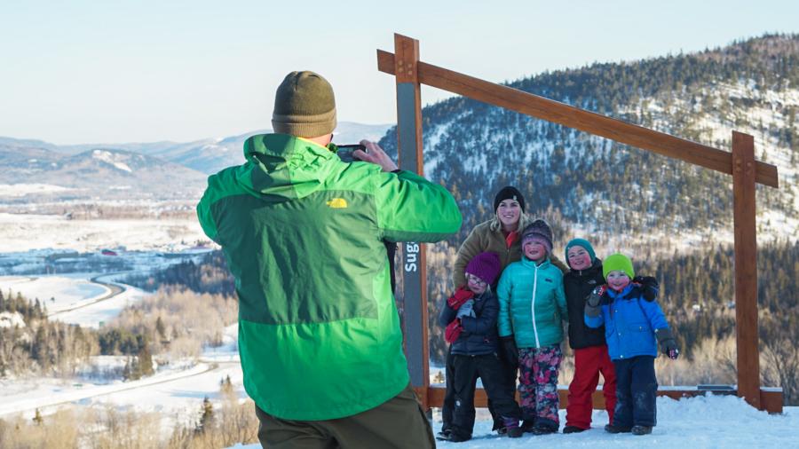 a man taking a picture of his family at Sugarloaf