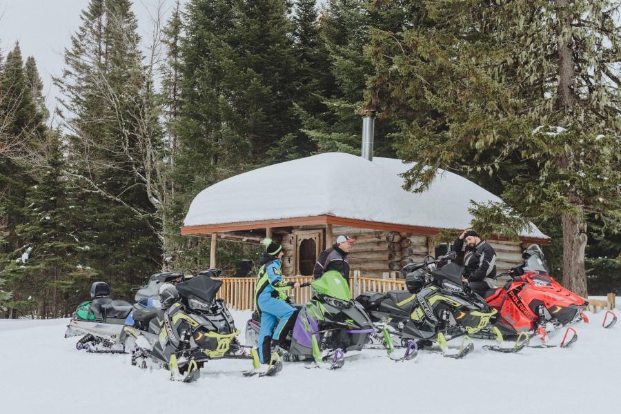 a group of people snowmobiling at mount carleton provincial park