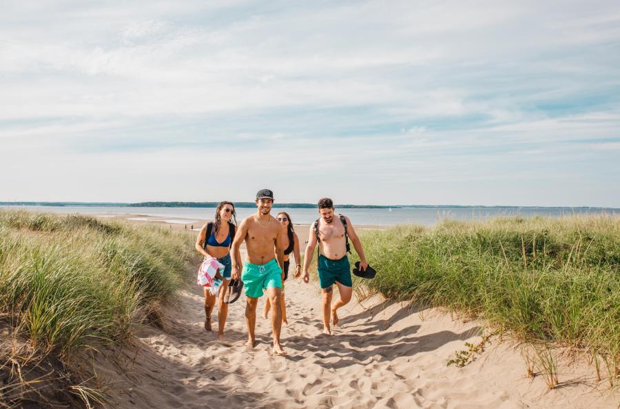 people walking up a sandy path from Parlee Beach