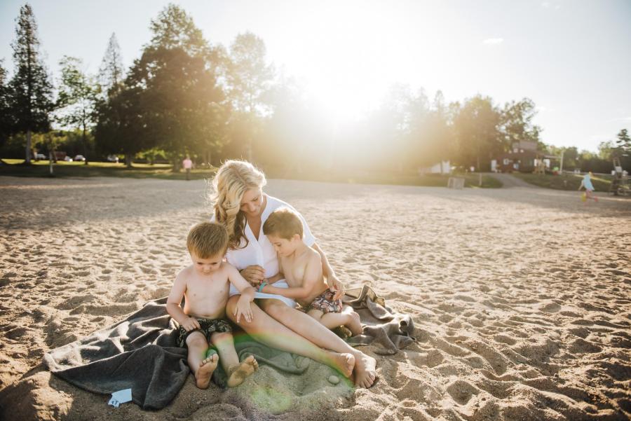 family on the beach at mactaquac provincial park