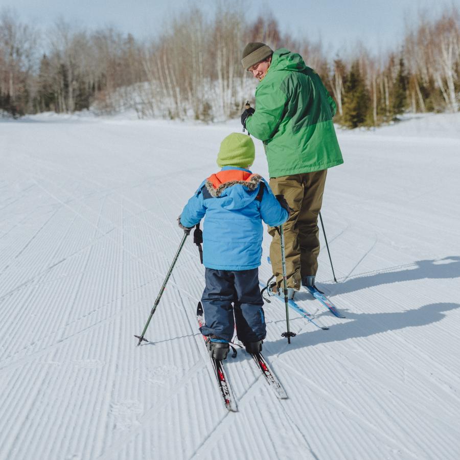 Adult and child cross-country skiing