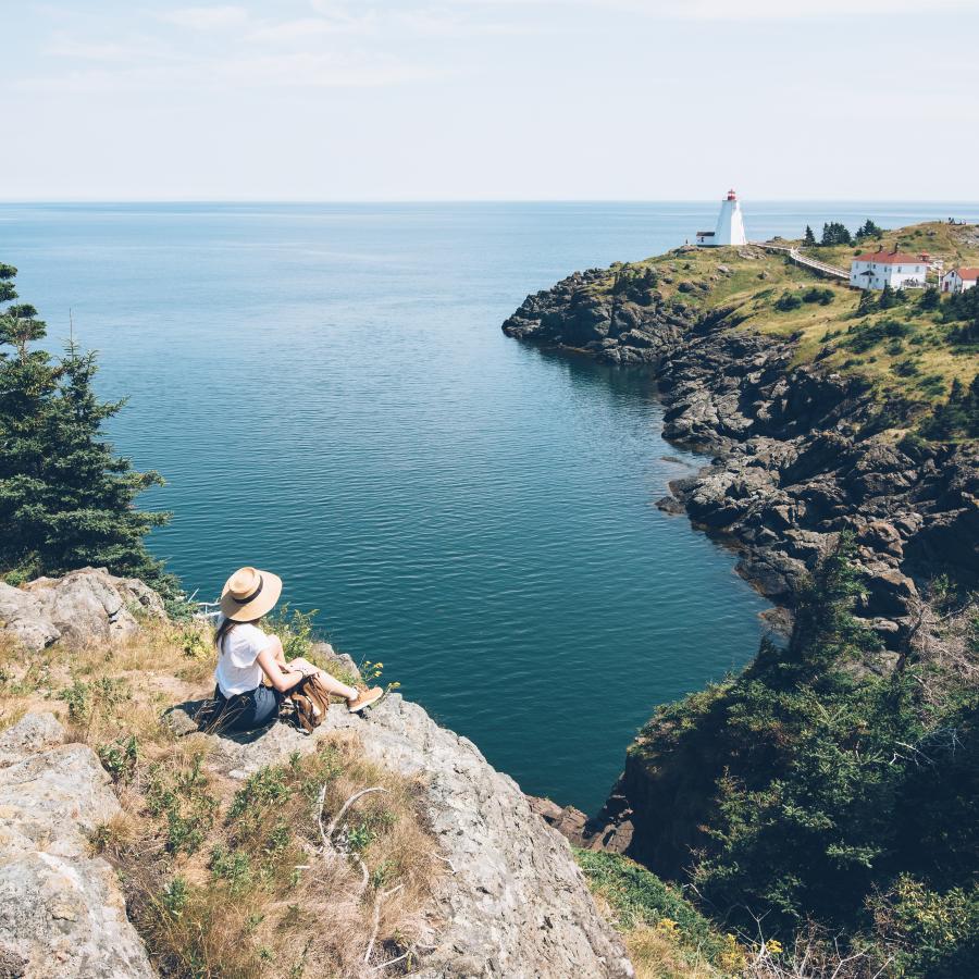 a girl looking at the cliff view on grand manan